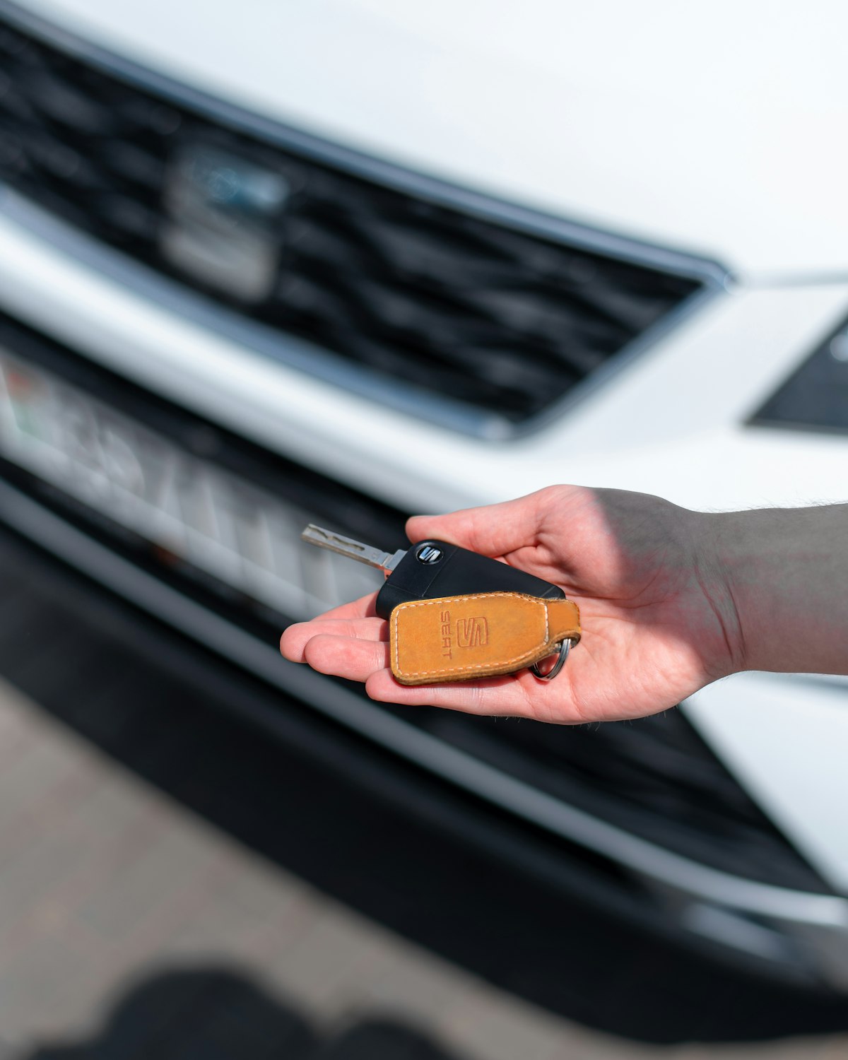 Person holding car keys inside a vehicle