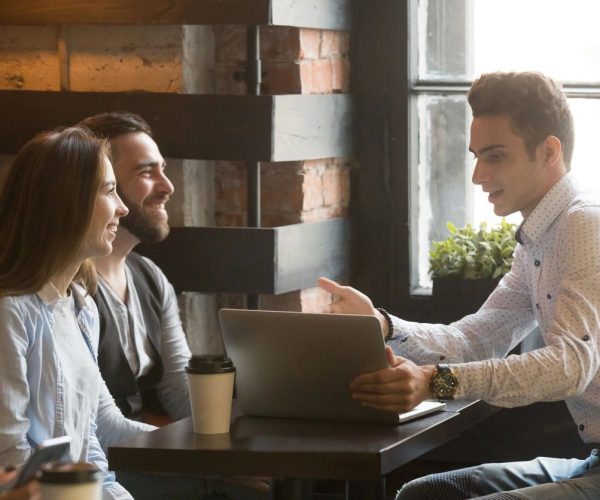 A couple sitting down and talking to a mortgage broker.